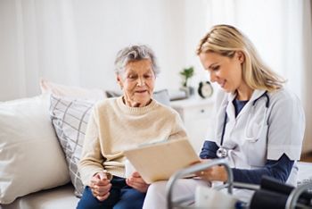 A health visitor and a senior woman sitting on a bed at home, talking.; Shutterstock ID 1240839277; purchase_order: DNC Thumbnails; job: Webinars 3 (50/188); client: ; other: 