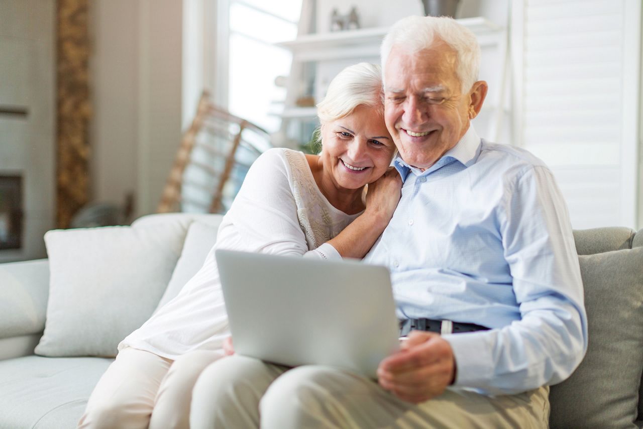 Senior couple using laptop computer at home