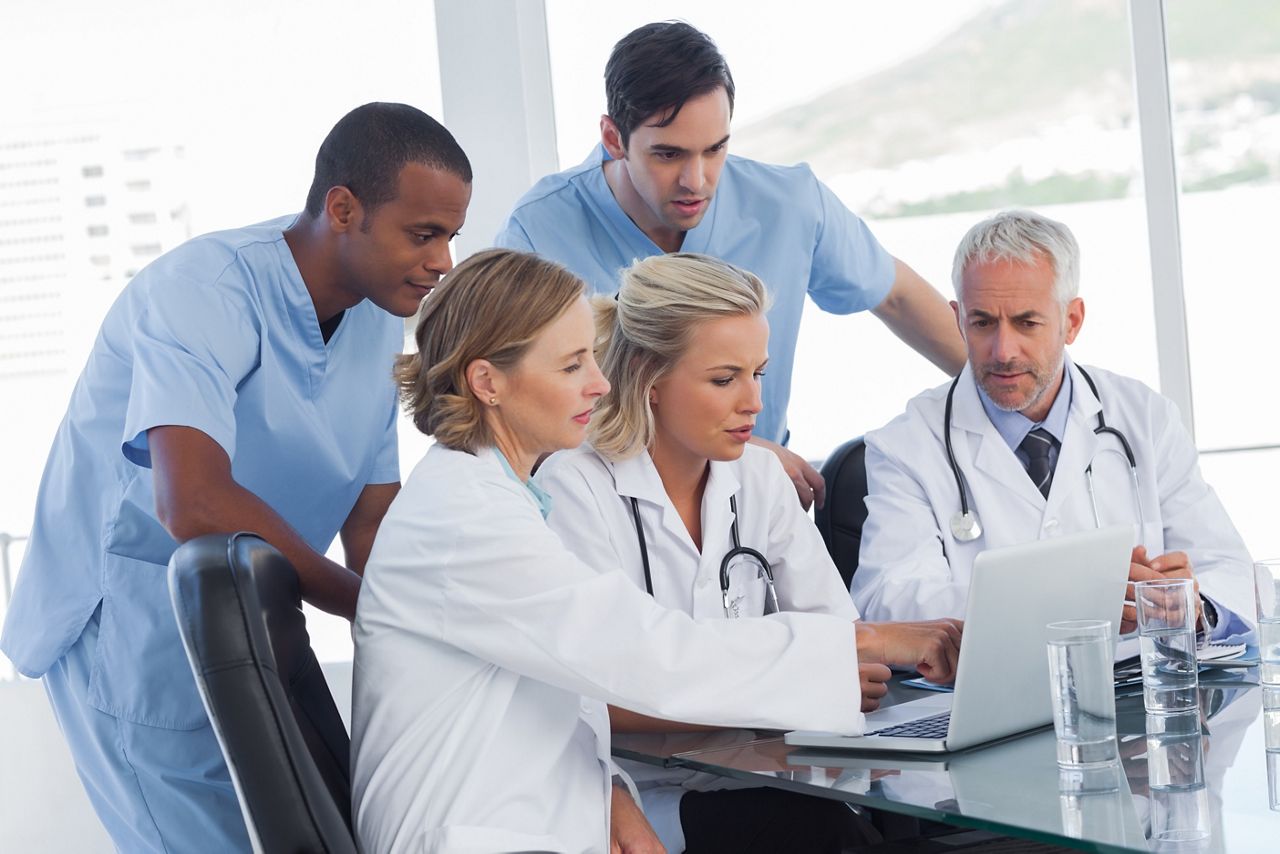 Serious medical team using a laptop in a bright office; Shutterstock ID 138016538; purchase_order: DNC Thumbnails; job: Webinars 1 (50/189); client: ; other: 