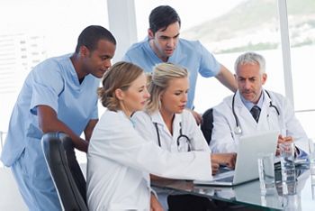 Serious medical team using a laptop in a bright office; Shutterstock ID 138016538; purchase_order: DNC Thumbnails; job: Webinars 1 (50/189); client: ; other: 