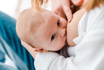 partial view of woman breastfeeding baby at home; Shutterstock ID 1390770353; purchase_order: DNC Thumbnails; job: Booklets; client: ; other: 