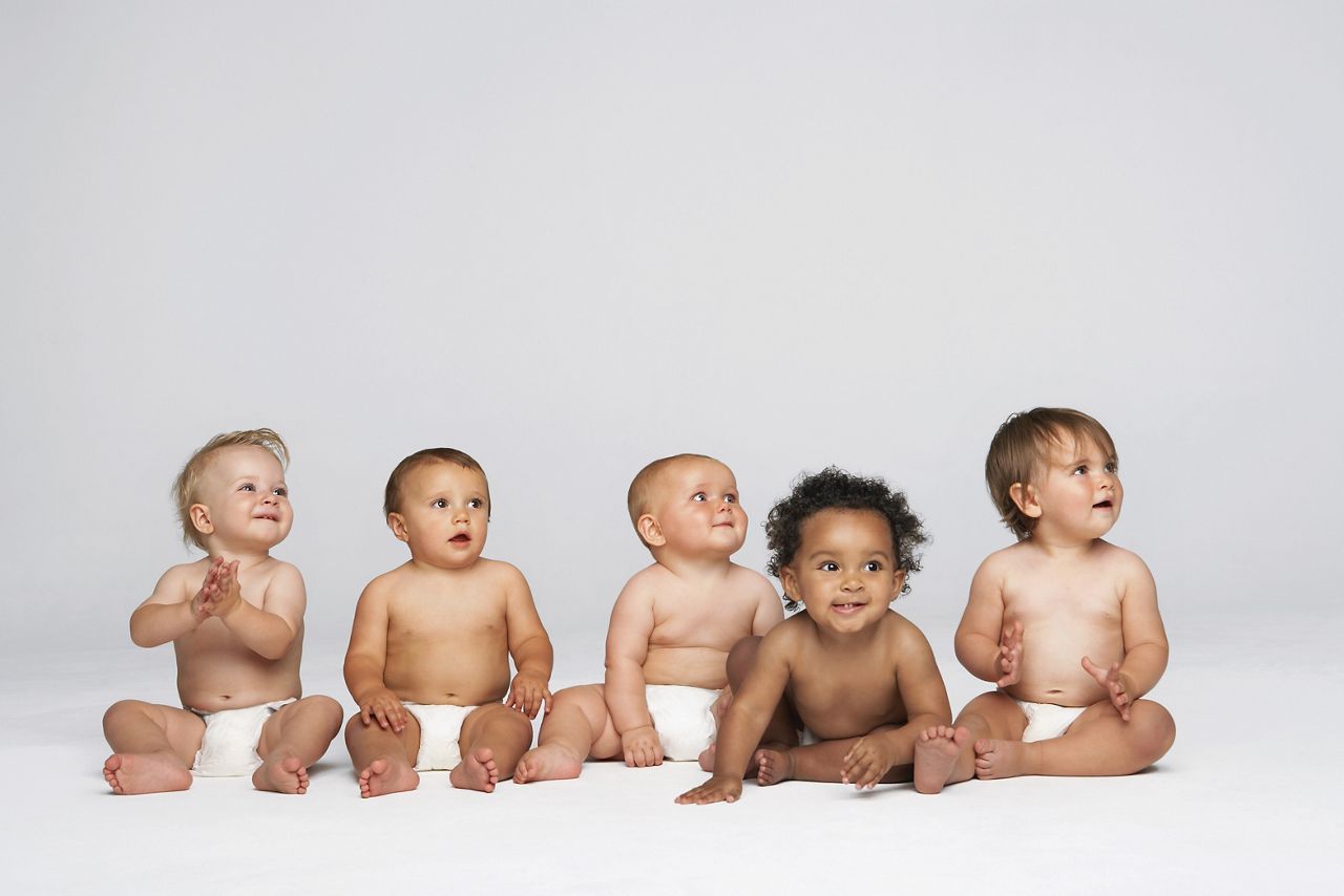 Row of multiethnic babies sitting side by side looking away isolated on gray background; Shutterstock ID 144900970; purchase_order: DNC Thumbnails; job: Collections; client: ; other: 