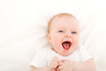 happy smiling child with blue eyes lying in bed over white; Shutterstock ID 145080523; purchase_order: DNC Thumbnails; job: Webinars 1 (50/189); client: ; other: 