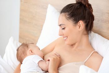 Young woman breastfeeding her baby at home; Shutterstock ID 1452282575; purchase_order: DNC Thumbnails; job: Publications; client: ; other: Replace Fishwife