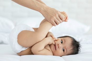 Close up mother Hands Holding Baby leg and Exercise for Healthy on bed smiling and  happiness emotional in cozy bedroom,Exercise Healthy Baby Concept; Shutterstock ID 1453447595; purchase_order: SN event thumbnails; job: ; client: ; other: 