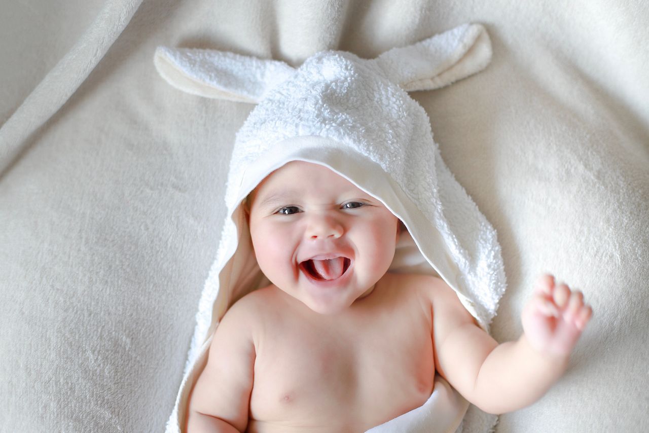 Adorable newborn baby wrap by white rabbit towel with smiling face. Happy mixed race Asian-German boy drying after bathing; Shutterstock ID 1481722679; purchase_order: DNC Thumbnails; job: Webinars 1 (50/189); client: ; other: 