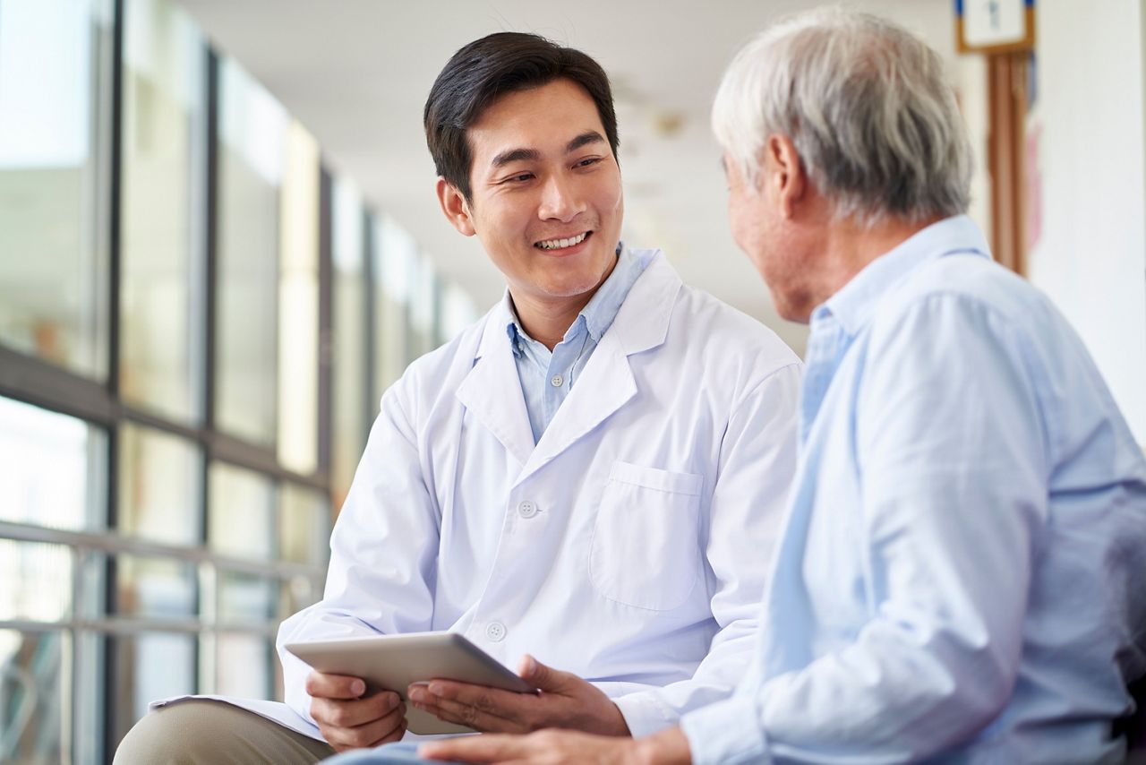 friendly smiling young asian doctor talking and explaining test result to elderly patient in hospital; Shutterstock ID 1639731790; purchase_order: DNC Thumbnails; job: Publications; client: ; other: 