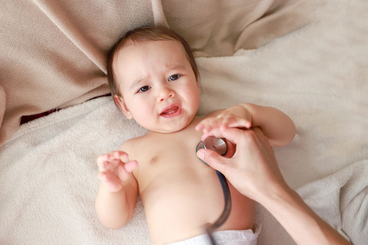 Crying baby boy pediatrician examining with stethoscope. Mixed race Asian-German infant,doctor checking and listen to heart beat.; Shutterstock ID 1648009747; purchase_order: DNC Thumbnails; job: Webinars; client: ; other: Replacements