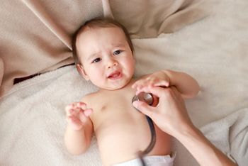 Crying baby boy pediatrician examining with stethoscope. Mixed race Asian-German infant,doctor checking and listen to heart beat.; Shutterstock ID 1648009747; purchase_order: DNC Thumbnails; job: Webinars; client: ; other: Replacements