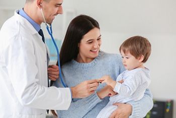 Woman with little baby visiting pediatrician in clinic; Shutterstock ID 1669849573; purchase_order: 25 thumbnail photos ; job: ; client: ; other: 