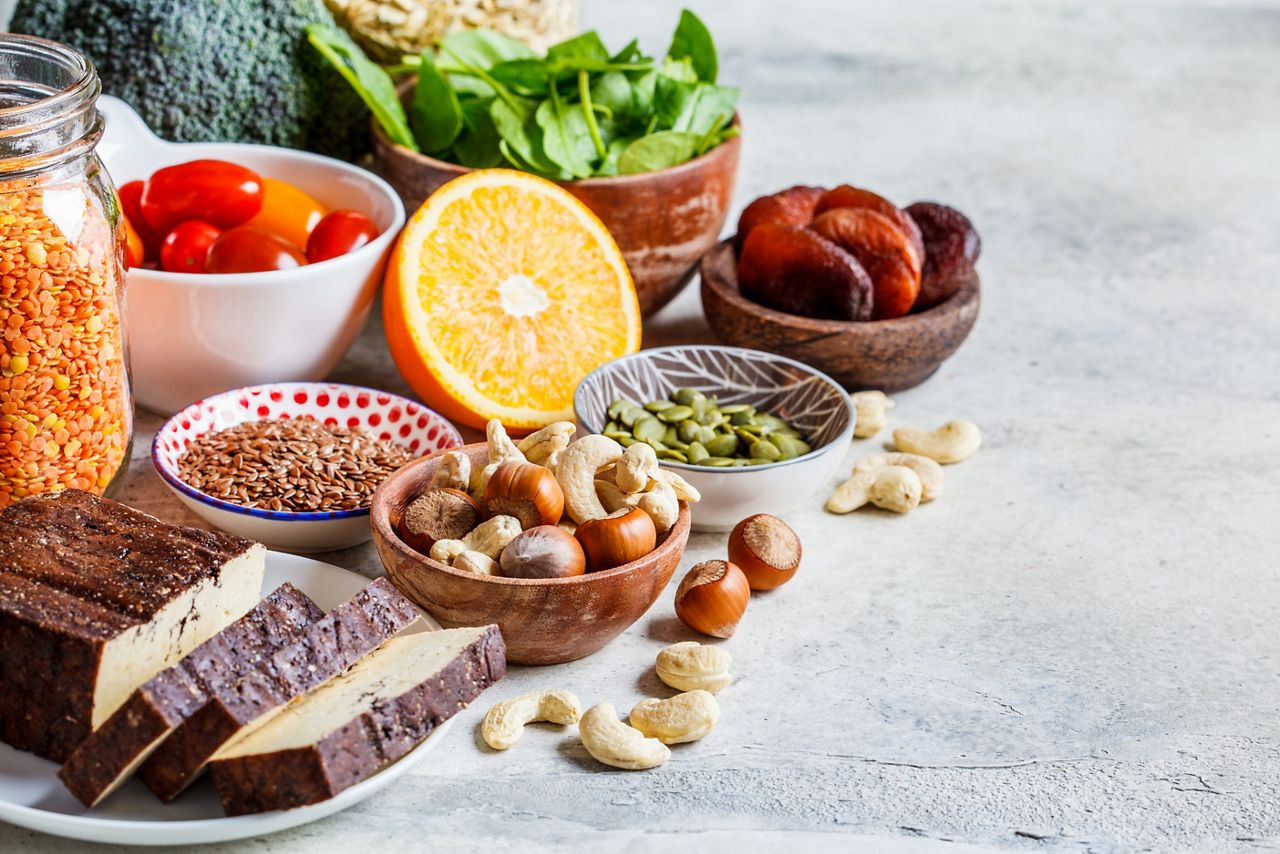 Plant based sources of iron background. Oatmeal, lentils, tofu, broccoli, dried apricots and nuts are iron-rich foods.; Shutterstock ID 1674378484; purchase_order: DNC Thumbnails; job: Infographics; client: ; other: 