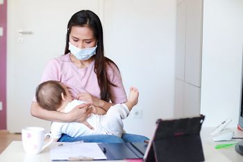 Young mother holding her newborn baby breastfeeding and wearing surgical face mask work from home online with tablet. Lock down isolation during coronavirus pandemic quarantine,covid-19 outbreak; Shutterstock ID 1691696077; purchase_order: DNC Thumbnails; job: Webinars 3 (50/188); client: ; other: 