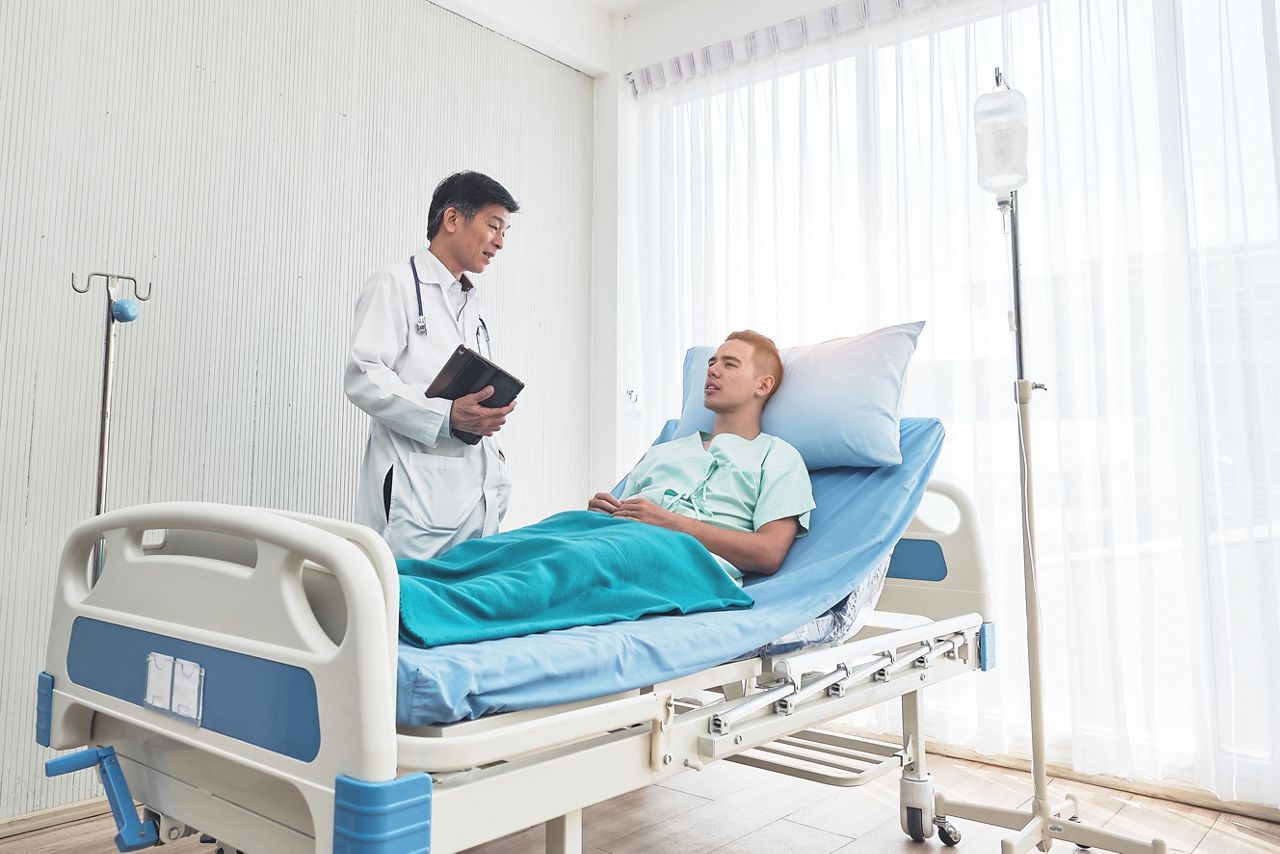 Young caucasian male patient on bed talking to doctor in hospital room, Health care and insurance concept.; Shutterstock ID 1692227323; purchase_order: DNC Thumbnails; job: Webinars 3 (50/188); client: ; other: 