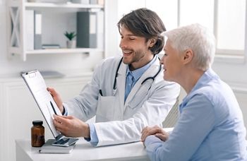 Defeated disease. Happy doctor showing positive test results to senior woman patient at hospital, free space; Shutterstock ID 1727099989; purchase_order: DNC Thu  ; job: ; client: ; other: 