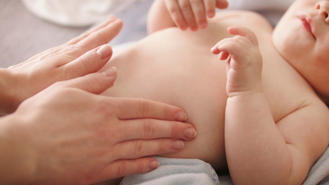 Mother massaging baby tummy. Baby skin care and development concept.; Shutterstock ID 1735041425; purchase_order: DNC Thumbnails; job: Webinars 3 (50/188); client: ; other: 