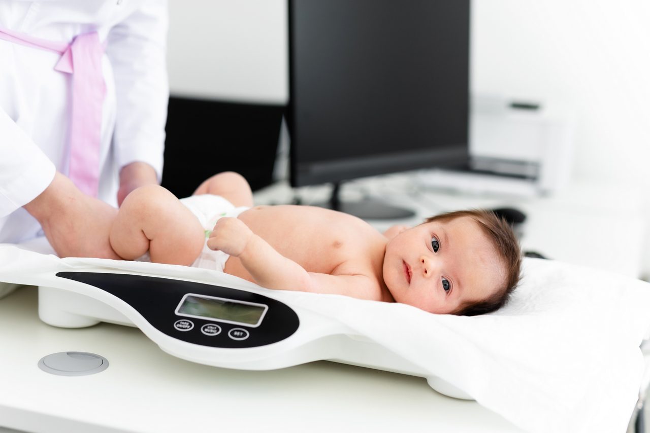 Close-up of a doctor checking weight of cute little baby. Healthcare concept.; Shutterstock ID 1745783105; purchase_order: PR2138319; job: OMG1131771 ; client: Healthcare NPS; other: 336