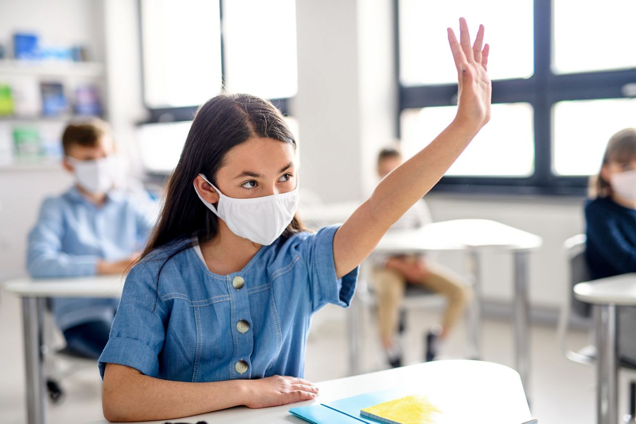 Girl with face mask back at school after covid-19 quarantine and lockdown.; Shutterstock ID 1751409815; purchase_order: DNC Thumbnails; job: Webinars 3 (50/188); client: ; other: 