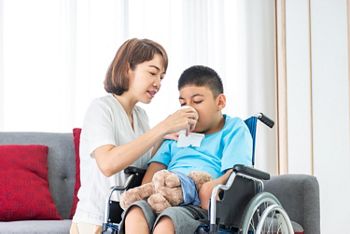 asian mother feeding drinking water to disabled child on wheelchair; Shutterstock ID 1774560467; purchase_order: DNC Thumbnails; job: Webinars 1 (50/189); client: ; other: 