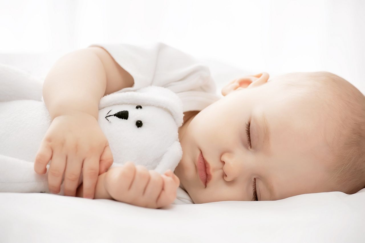 Carefree sleep little baby with a soft toy on the bed; Shutterstock ID 189429191; purchase_order: DNC Thumbnails; job: Articles; client: ; other: 