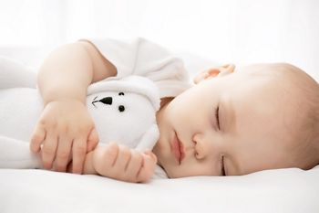 Carefree sleep little baby with a soft toy on the bed; Shutterstock ID 189429191; purchase_order: DNC Thumbnails; job: Articles; client: ; other: 