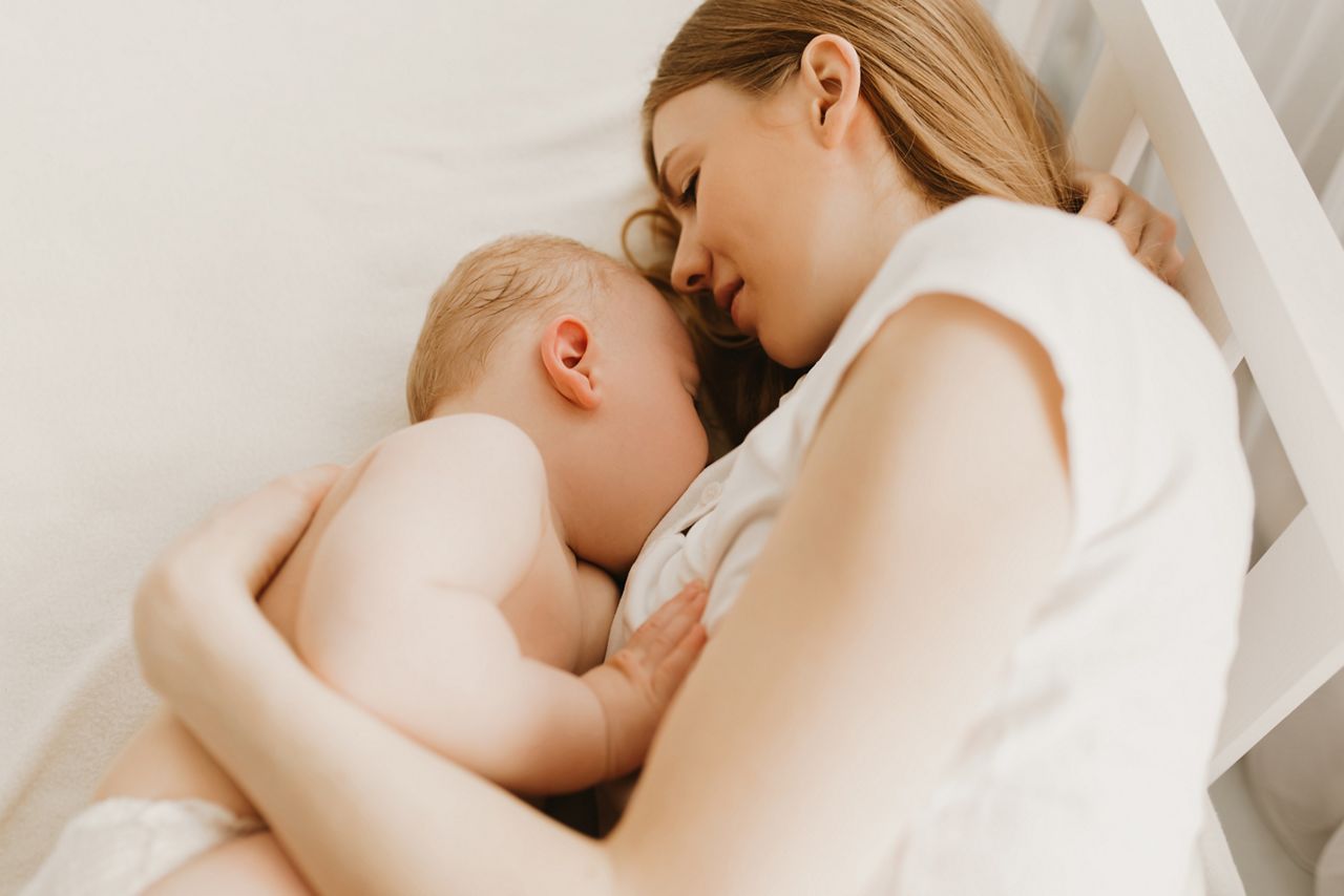 Beautiful young mom and her cute little baby sleeping in bed at home; Shutterstock ID 1919439980; purchase_order: DNC Thumbnails; job: Publications; client: ; other: 