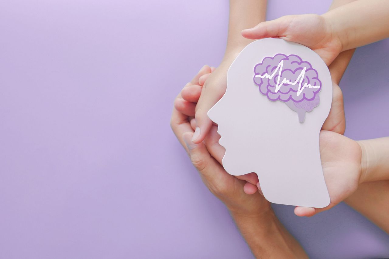 Adult and child hands holding encephalography brain paper cutout,autism, Stroke, Epilepsy and alzheimer awareness, seizure disorder, stroke, ADHD, world mental health day concept; Shutterstock ID 1932094208; purchase_order: DNC Thumbnails; job: Webinars 2 (50/188); client: ; other: 