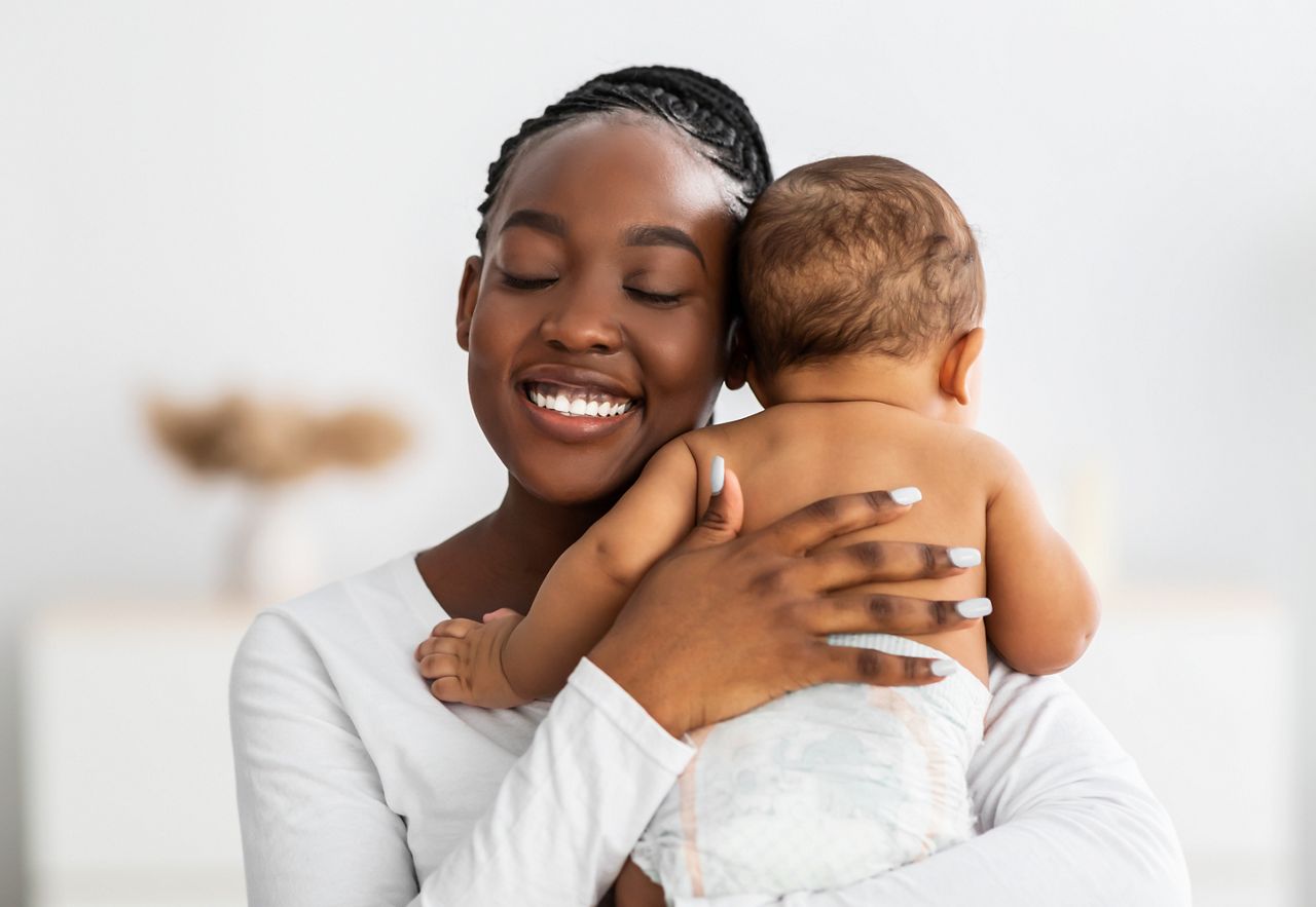 African American mom hugging her cute infant; Shutterstock ID 1937816869; purchase_order: DNC Thumbnails; job: Webinars 1 (50/189); client: ; other: 