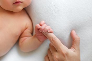The newborn is holding a finger of mother on a white background. The newborn squeezes a finger. Family and home concept. Healthcare, pediatrics. Motherhood. Newborn and parent. Baby. Copy space; Shutterstock ID 1943188627; purchase_order: SN event thumbnails; job: ; client: ; other: 