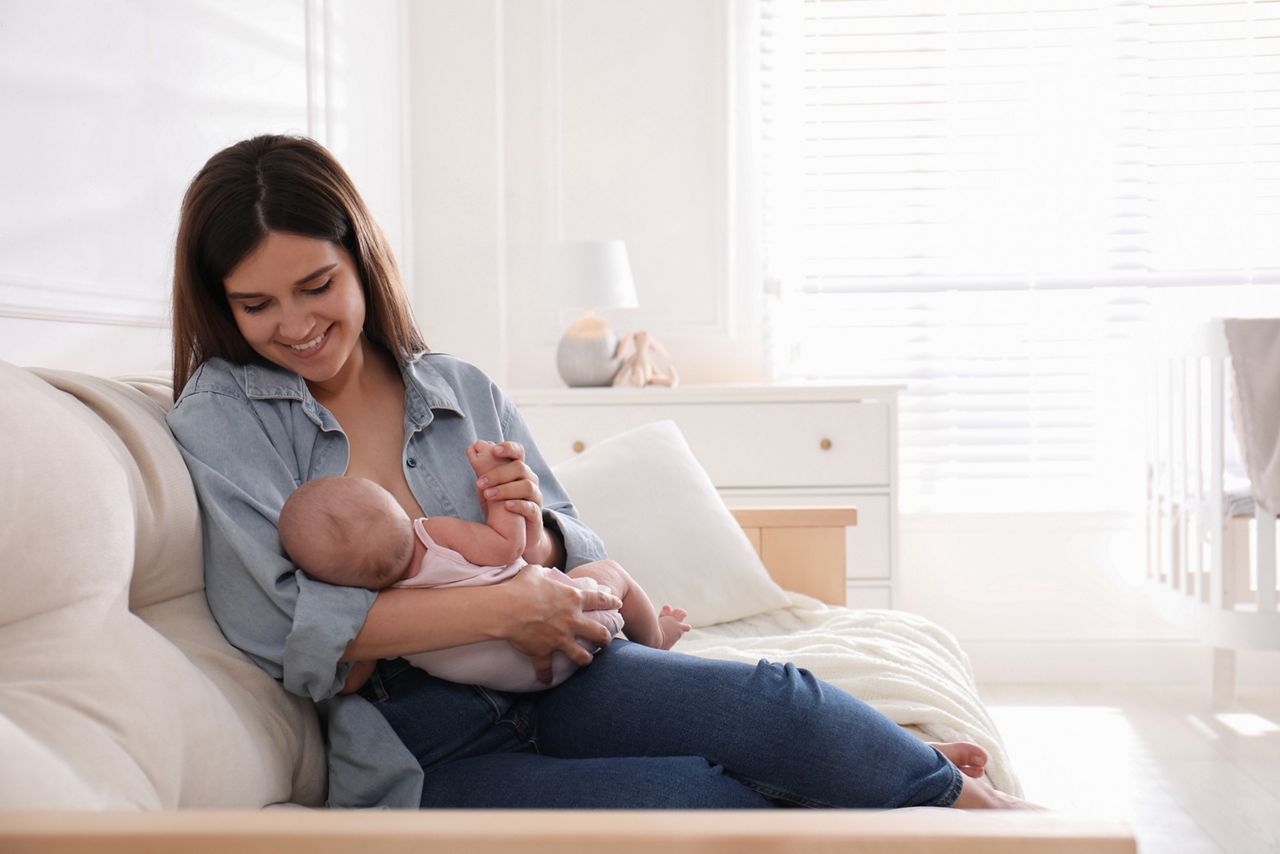 Young woman breastfeeding her little baby at home, space for text; Shutterstock ID 2023799822; purchase_order: DNC Thumbnails; job: Videos; client: ; other: 
