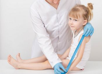 The doctor measures the length of the arm of a child of a girl 4 years old. Child growth measurement and anthropometric data concept. Copy space for text; Shutterstock ID 2037416336; purchase_order: SN event thumbnails; job: ; client: ; other: 