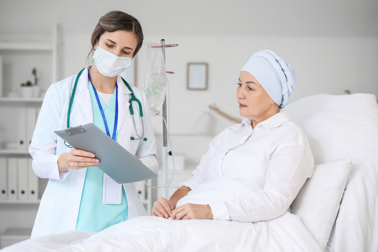 Doctor telling news to mature woman after chemotherapy in clinic; Shutterstock ID 2088789445; purchase_order: SN event thumbnails; job: ; client: ; other: 