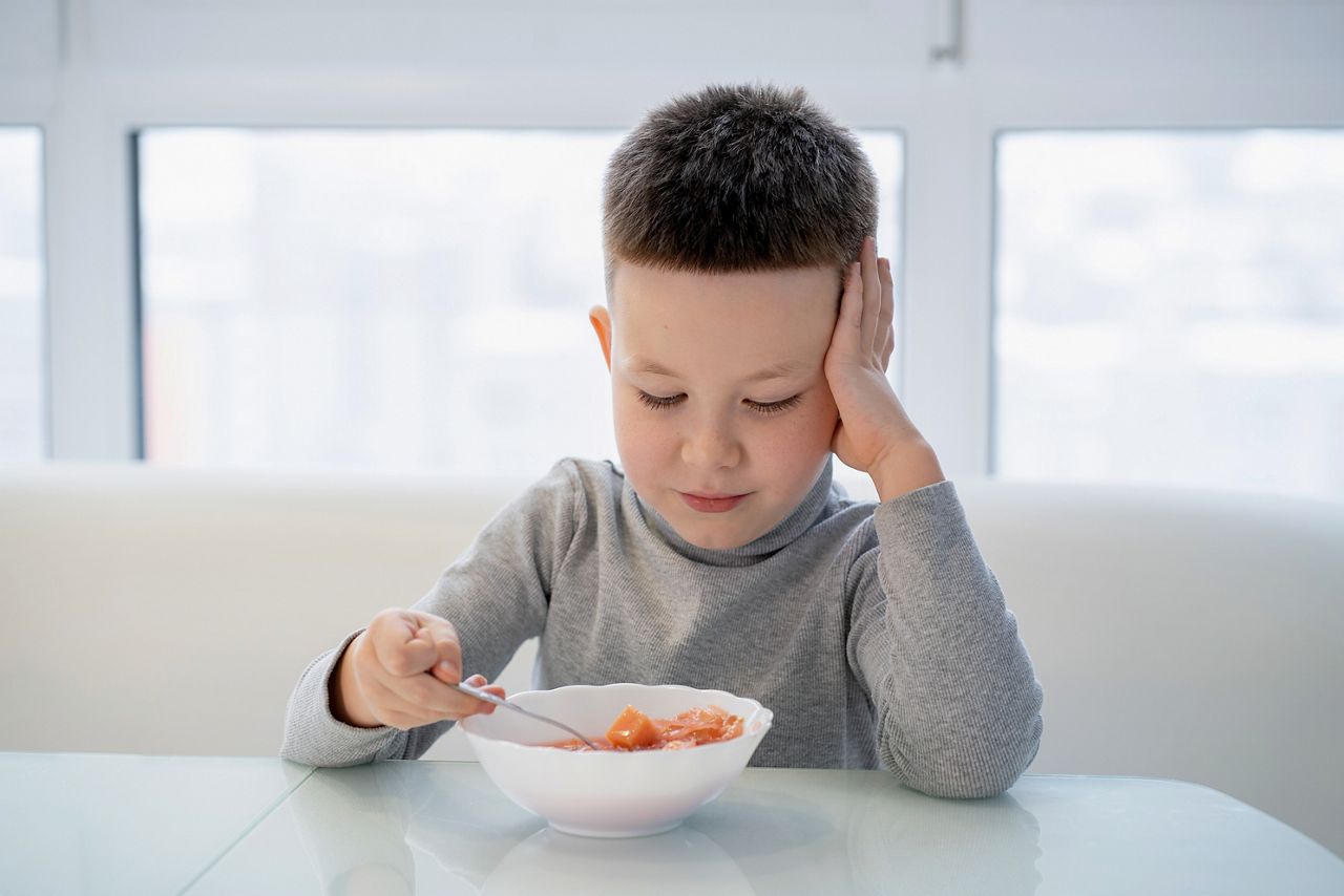 Little boy sits at the table and does not want to eat soup; Shutterstock ID 2102872075; purchase_order: DNC Thumbnails; job: Infographics; client: ; other: 