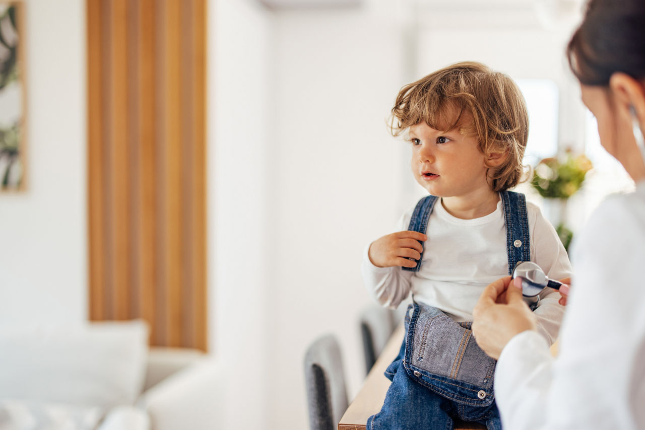 Toddler sitting still, being calm while getting ready for the appointment.