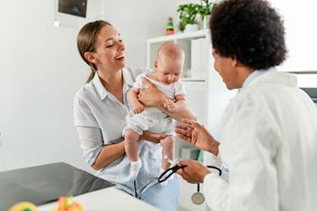 Pediatrician doctor concept. Children medical care. Infant child examined by female pediatrician in clinic office. Child visiting doctor for health check-up. Doctor examine little patient.; Shutterstock ID 2172799267; purchase_order: DNC Thu  ; job: ; client: ; other: 