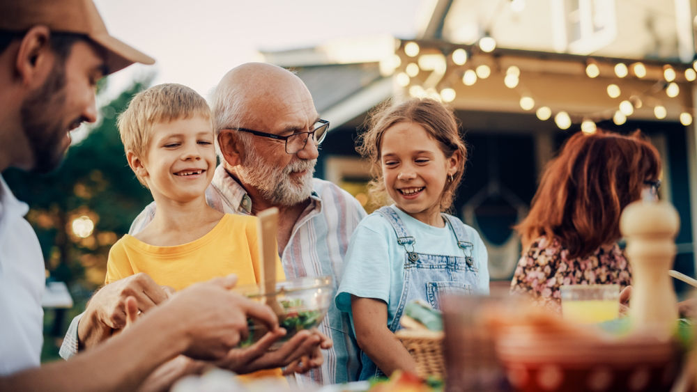 Grandfather cuddling grandchildren