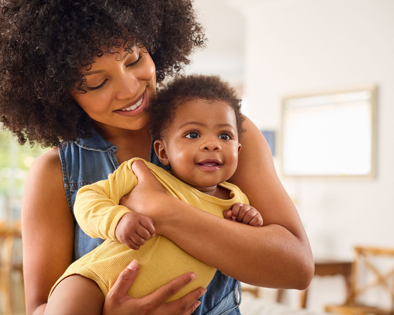 Loving Mother Indoors At Home Standing Cuddling Baby Daughter; Shutterstock ID 2455634363; purchase_order: -; job: -; client: -; other: -