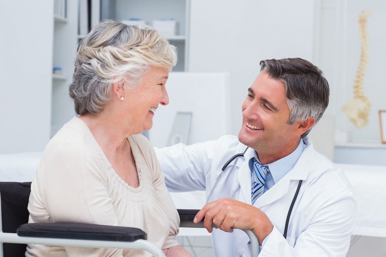 Happy male doctor looking at female patient in clinic; Shutterstock ID 257431399; purchase_order: DNC Thu  ; job: ; client: ; other: 