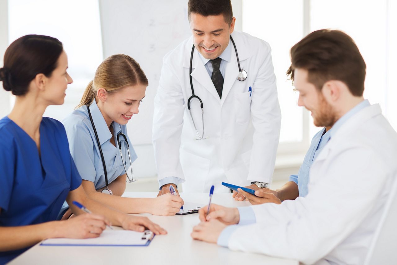 hospital, profession, people and medicine concept - group of happy doctors meeting and taking notes at medical office; Shutterstock ID 283179098; purchase_order: DNC Thu  ; job: ; client: ; other: 