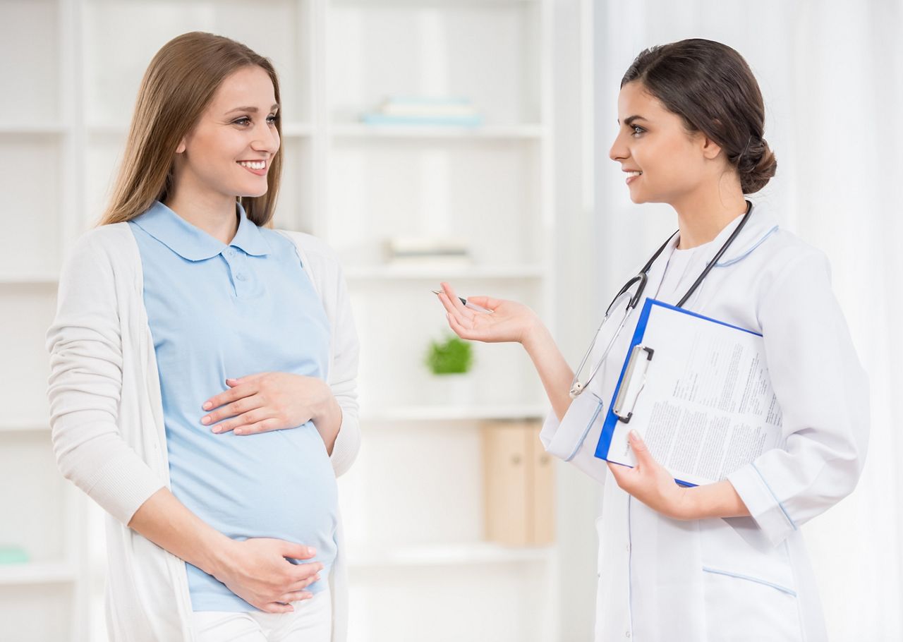Doctor explaining something to her pregnant patient at clinic.; Shutterstock ID 284887796; purchase_order: DNC Thu  ; job: ; client: ; other: 