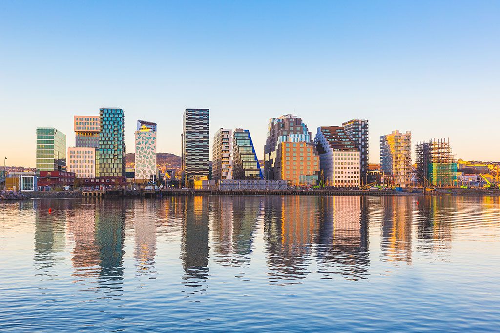 Modern buildings in Oslo, Norway, with their reflection into the water. These are some of the new buildings in the neighbourhood of Bjorvika. Concepts of travel and architecture.; Shutterstock ID 350327231; purchase_order: DNC Thumbnails; job: Events; client: ; other: 