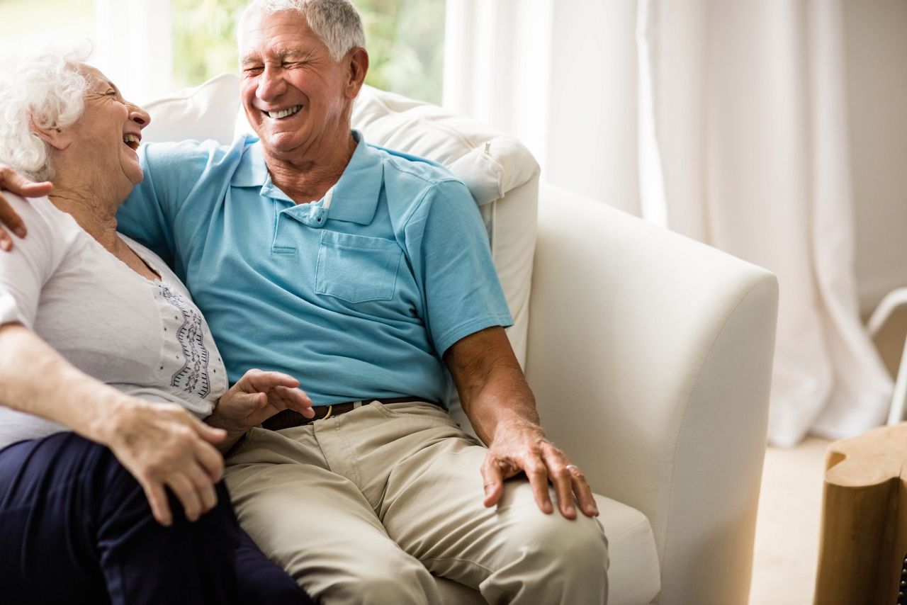 Close up of cute senior couple hugging on sofa; Shutterstock ID 372342940; purchase_order: DNC Thumbnails; job: Webinars 2 (50/188); client: ; other: 