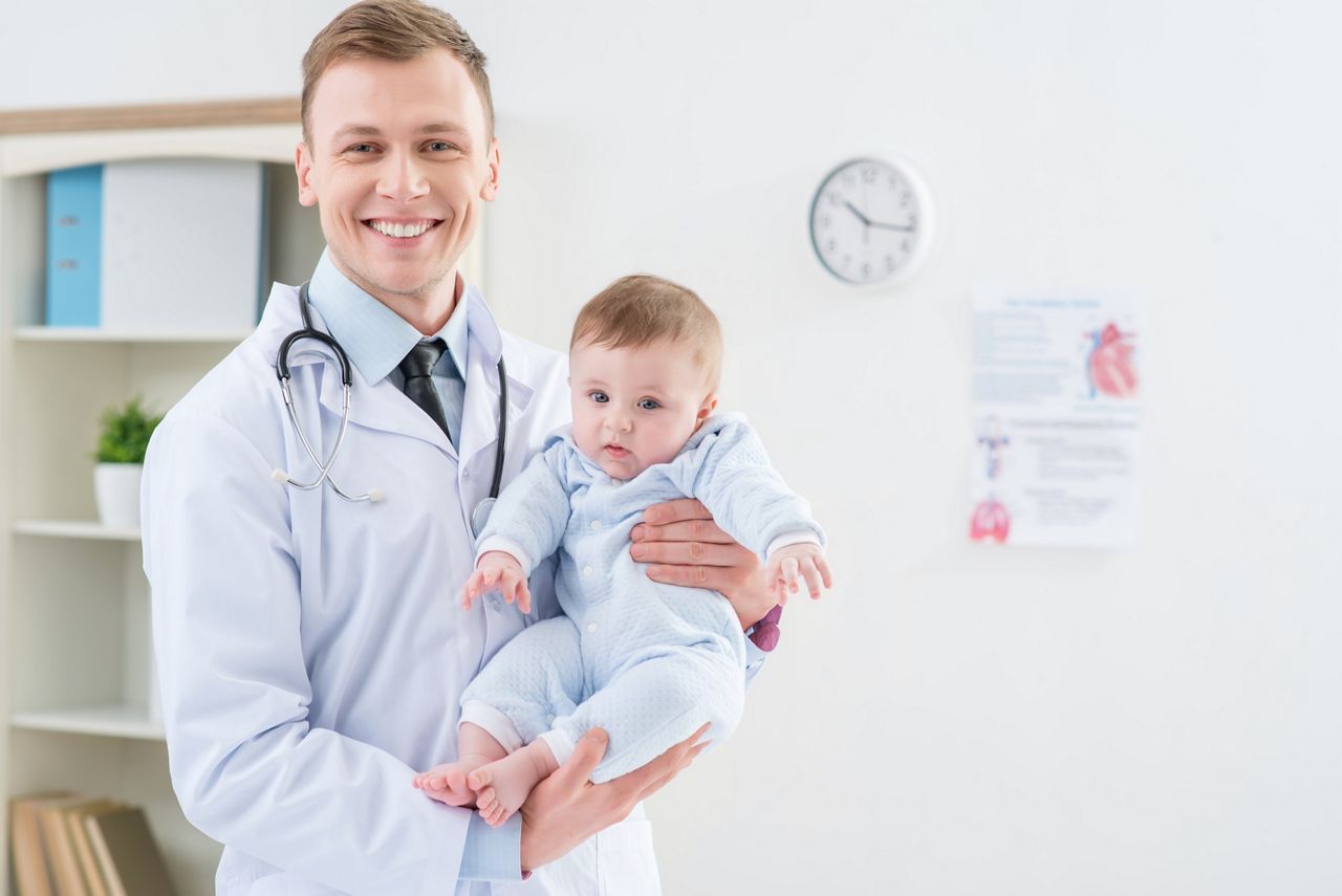 Professional pediatrician holding infant ; Shutterstock ID 372633088; purchase_order: DNC Thumbnails; job: Courses; client: ; other: Replace Fishwife