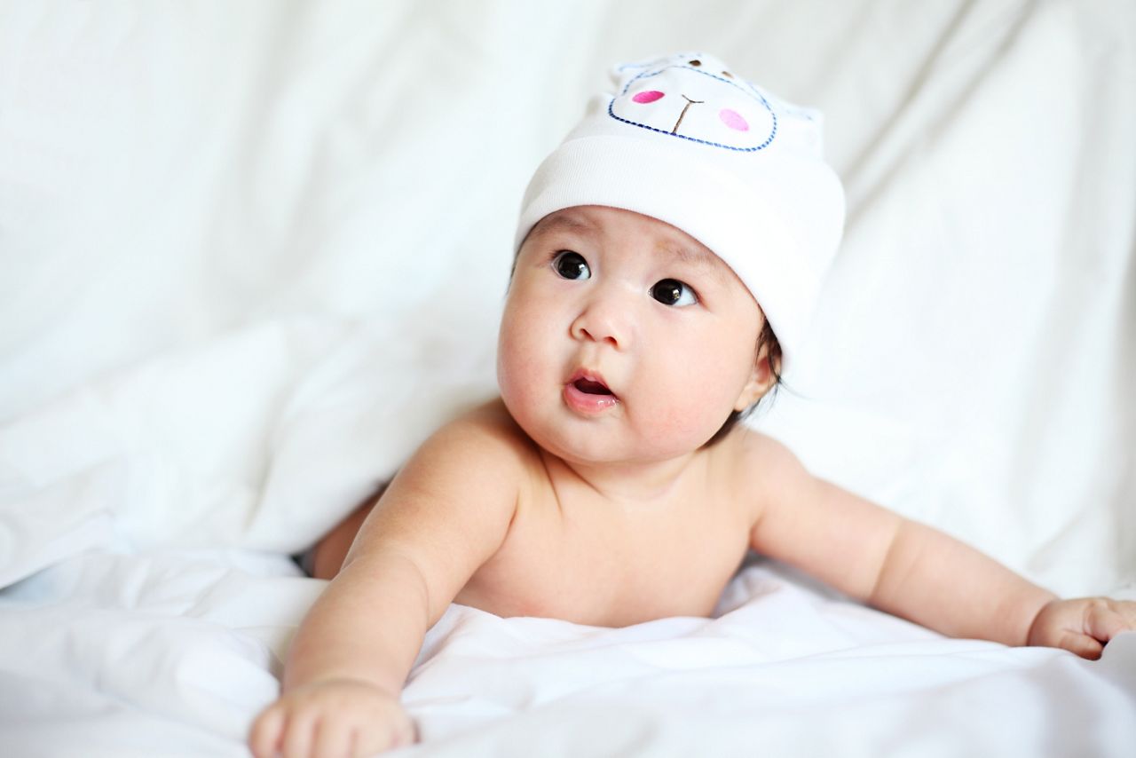 Newborn Baby with Cow Hat Lying Down on a Blanket; Shutterstock ID 405952750; purchase_order: DNC Thumbnails; job: Webinars 3 (50/188); client: ; other: 