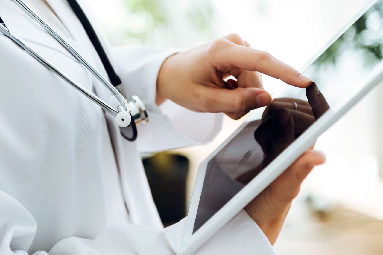 Portrait of female doctor using her digital tablet in the office.; Shutterstock ID 519463747; purchase_order: DNC Thu  ; job: ; client: ; other: 