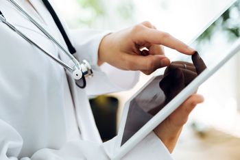 Portrait of female doctor using her digital tablet in the office.; Shutterstock ID 519463747; purchase_order: DNC Thu  ; job: ; client: ; other: 