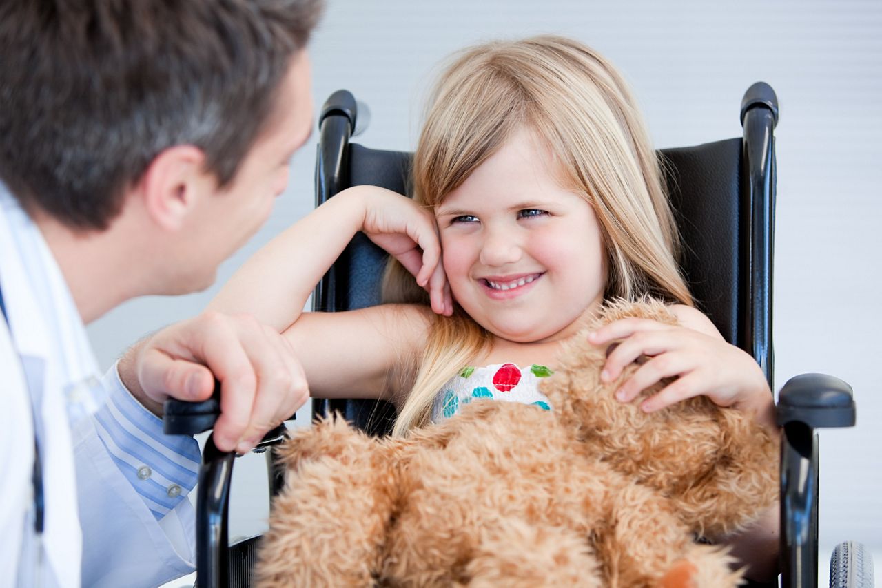 Laughing little girl sitting on the wheelchair at the hospital; Shutterstock ID 52821739; purchase_order: DNC Thumbnails; job: Article; client: ; other: Replacement