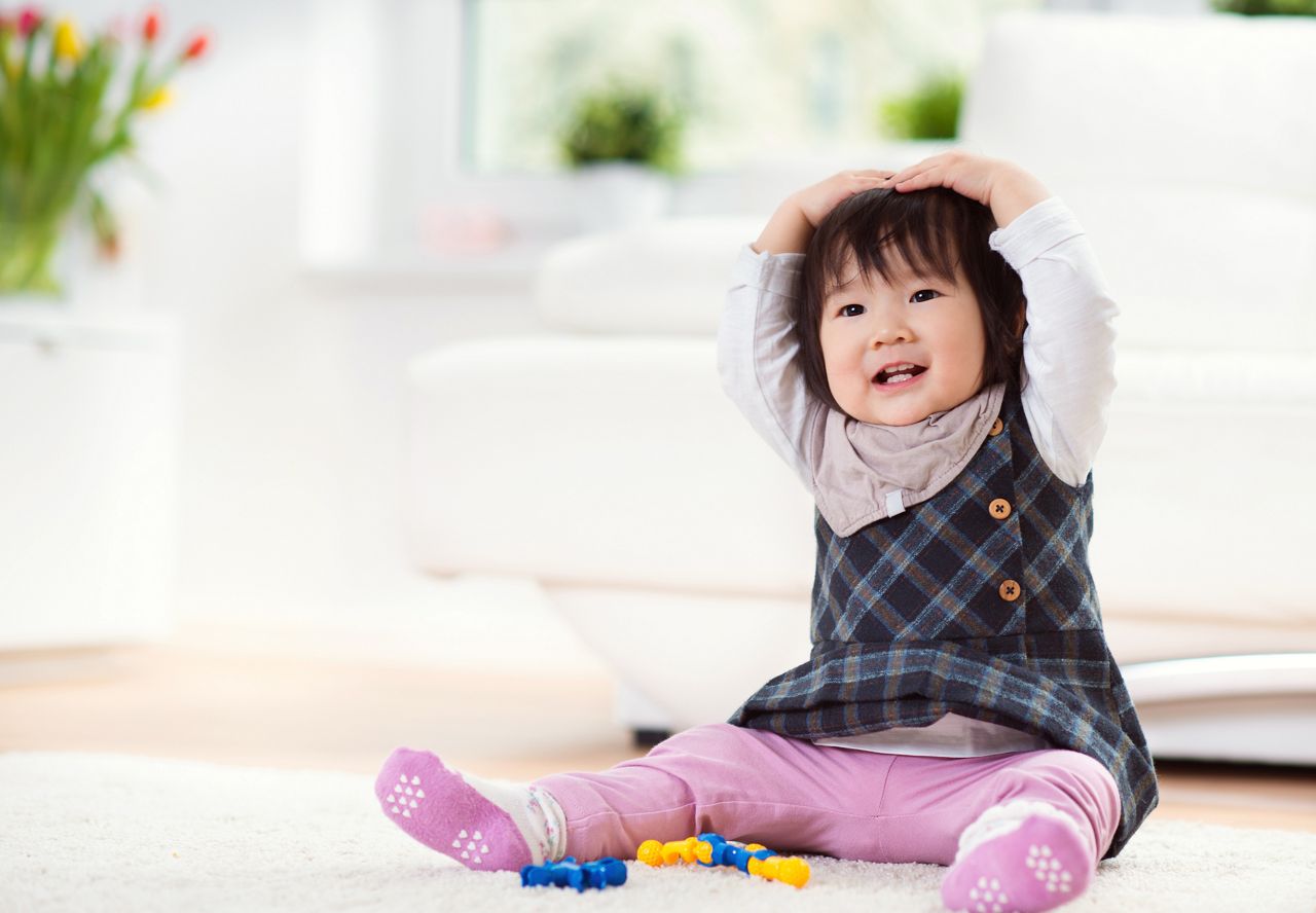 Pretty happy little japanese child girl playing on white capet at home; Shutterstock ID 573009043; purchase_order: DNC Thumbnails; job: Publications; client: ; other: Replace Fishwife