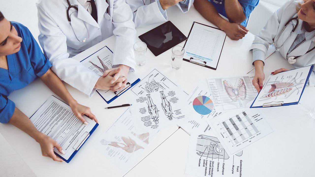 Cropped image of successful medical doctors discussing diagnosis during the conference; Shutterstock ID 582901018; purchase_order: DNC Thumbnails; job: Webinars 2 (50/188); client: ; other: 