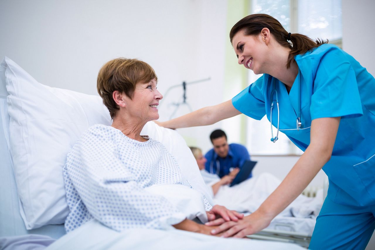 Nurse consoling a patient in ward at hospital; Shutterstock ID 584333368; purchase_order: DNC Thumbnails; job: Webinars 3 (50/188); client: ; other: 