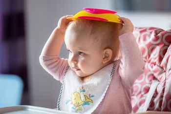 Little girl fussy eater sitting on the high chair; Shutterstock ID 594795488; purchase_order: DNC Thumbnails; job: Articles; client: ; other: 